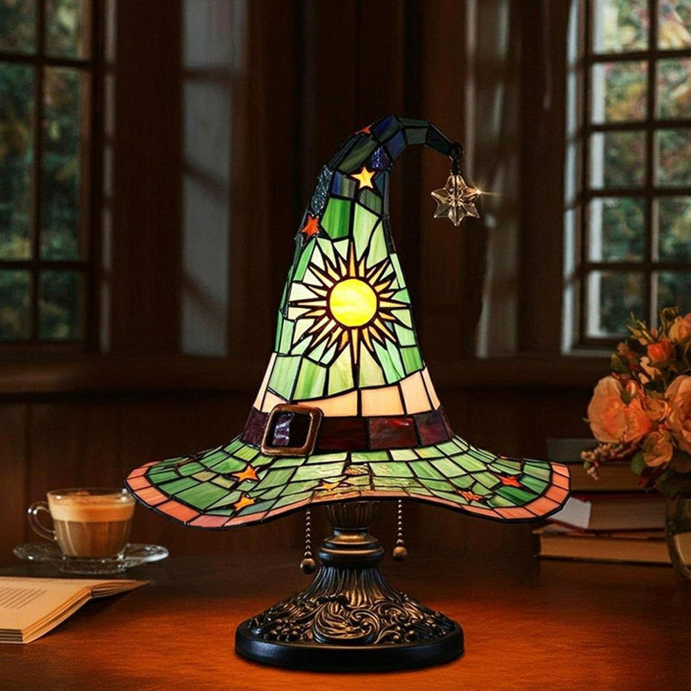 Green celestial witch hat lamp on a wooden desk