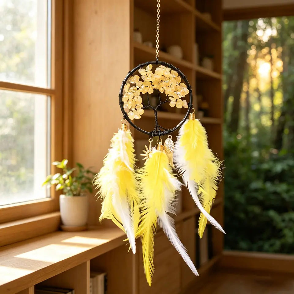 Golden yellow crystal Tree of Life feather hanging in a warm interior
